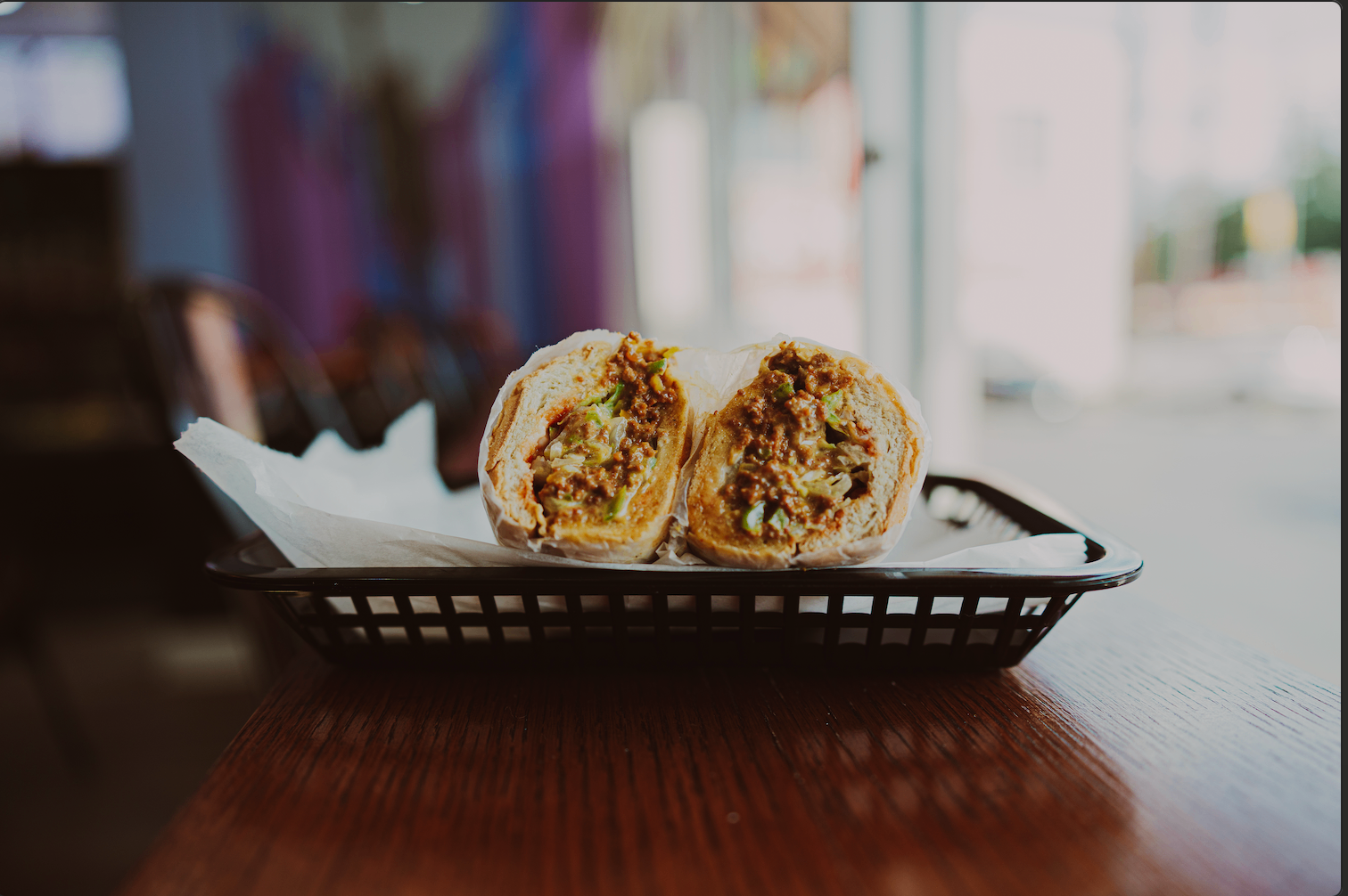 Hot chopped sandwich served in a basket by the window